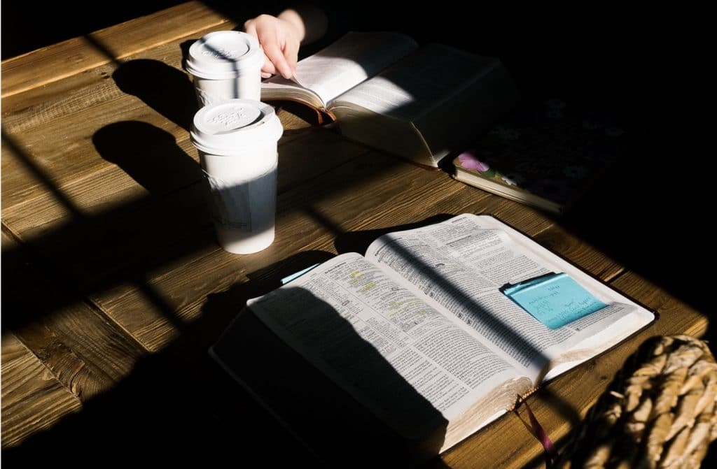 Two Bibles open on table with two cups of coffee, two person Bible Study