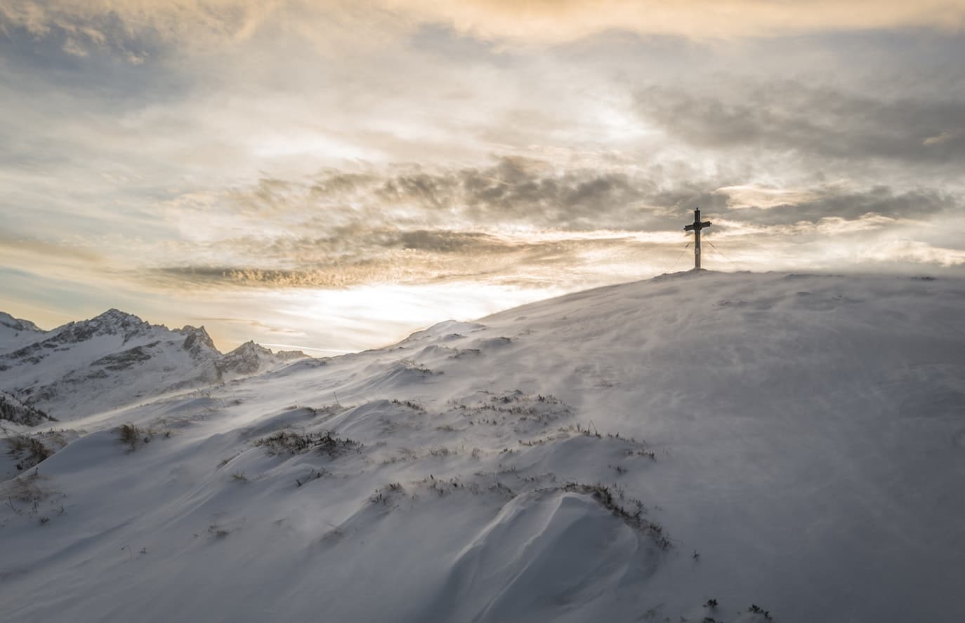 cross on snowy mountain